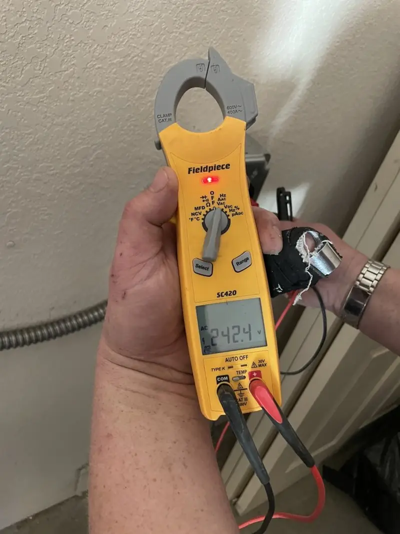 Voltage testing with clamp meter during Electrical Installation Services in Falfurrias